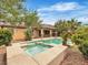 Inviting backyard featuring a pool, spa, desert landscaping, and covered patio, creating a perfect outdoor retreat at 7505 Java Sparrow St, North Las Vegas, NV 89084