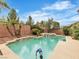 Inviting backyard pool and spa surrounded by desert landscaping, perfect for outdoor relaxation and entertaining at 7505 Java Sparrow St, North Las Vegas, NV 89084