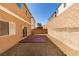 Gravel backyard with concrete patio and block wall offers a low-maintenance outdoor space at 7609 Aubusson Ct, Las Vegas, NV 89149