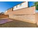The backyard is enclosed by a block wall and features gravel and a small paved area at 7609 Aubusson Ct, Las Vegas, NV 89149