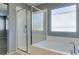 Bathroom featuring a shower, a tub, and a window for bright, natural light at 7609 Aubusson Ct, Las Vegas, NV 89149