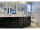 Bathroom features a double vanity, a mirror, and ample lighting for daily routines at 7609 Aubusson Ct, Las Vegas, NV 89149