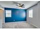 Spacious bedroom featuring modern paint colors, ceiling fan, and natural light from windows at 7609 Aubusson Ct, Las Vegas, NV 89149