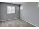 A cozy bedroom with carpet, a large window, and neutral walls creates a tranquil atmosphere at 7609 Aubusson Ct, Las Vegas, NV 89149