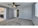 A large bedroom is carpeted and features a fan, three windows, and an ensuite bathroom at 7609 Aubusson Ct, Las Vegas, NV 89149