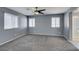 A carpeted bedroom offers a ceiling fan and natural light from three windows at 7609 Aubusson Ct, Las Vegas, NV 89149