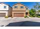 Two-story tan home featuring a two-car garage, neutral landscaping and a tile roof at 7609 Aubusson Ct, Las Vegas, NV 89149