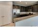Modern kitchen featuring stainless steel appliances, granite counters, and dark cabinets at 7609 Aubusson Ct, Las Vegas, NV 89149