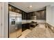 Well-equipped kitchen with stainless appliances, granite countertops, and dark wood cabinetry at 7609 Aubusson Ct, Las Vegas, NV 89149