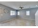 Spacious living room featuring open concept, tile flooring, neutral paint and a large clock at 7609 Aubusson Ct, Las Vegas, NV 89149