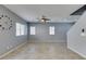 Spacious living room featuring open concept, tile flooring, neutral paint and a large clock at 7609 Aubusson Ct, Las Vegas, NV 89149