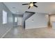 Spacious living room featuring open concept, tile flooring, neutral paint and a stairwell at 7609 Aubusson Ct, Las Vegas, NV 89149