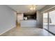 Open-concept living and dining area featuring tile floors and a sliding glass door leading to outdoor space at 7609 Aubusson Ct, Las Vegas, NV 89149