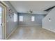 Bright living area featuring tile floors and natural light from a sliding glass door and window at 7609 Aubusson Ct, Las Vegas, NV 89149