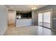 Open-concept living and dining area featuring tile floors and a sliding glass door to the backyard at 7609 Aubusson Ct, Las Vegas, NV 89149