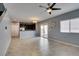 Spacious living room featuring open concept, tile flooring, neutral paint and a sliding glass door at 7609 Aubusson Ct, Las Vegas, NV 89149
