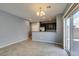 Open-concept living and dining area with access to patio via sliding glass doors at 7609 Aubusson Ct, Las Vegas, NV 89149