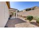 Relaxing backyard with covered patio area, desert landscaping, and gravel groundcover at 7669 Fieldfare Dr, North Las Vegas, NV 89084