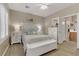 Serene bedroom featuring a white bed frame, wood-style floors, and ample natural light from the window at 7669 Fieldfare Dr, North Las Vegas, NV 89084