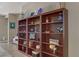 A three-section bookcase full of decorative items situated in the dining room at 7669 Fieldfare Dr, North Las Vegas, NV 89084