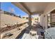 Outdoor covered patio with a desert view that features a grill and a small table and chairs at 7669 Fieldfare Dr, North Las Vegas, NV 89084