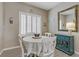 Charming dining area with shuttered windows, table setting and decorative blue cabinet at 7669 Fieldfare Dr, North Las Vegas, NV 89084
