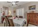 Open dining room featuring wooden furnishings, light walls, floors and large windows at 7669 Fieldfare Dr, North Las Vegas, NV 89084