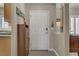 Bright foyer features a white front door, wood-look flooring, and stylish decor accents at 7669 Fieldfare Dr, North Las Vegas, NV 89084