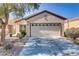 Charming single-story home with a two-car garage and well-maintained desert landscaping at 7669 Fieldfare Dr, North Las Vegas, NV 89084