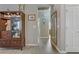 Inviting hallway featuring wood-look flooring, neutral walls, and a decorative display cabinet at 7669 Fieldfare Dr, North Las Vegas, NV 89084