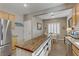 Bright kitchen featuring stainless steel appliances and a rustic wood-topped island at 7669 Fieldfare Dr, North Las Vegas, NV 89084