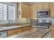 Well-equipped kitchen with stainless steel appliances, granite countertops, and ample cabinet space at 7669 Fieldfare Dr, North Las Vegas, NV 89084
