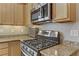 Updated kitchen featuring stainless steel oven range and ample wood cabinets at 7669 Fieldfare Dr, North Las Vegas, NV 89084