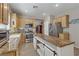 Modern kitchen with stainless steel appliances, an island with a wood countertop, and light wood cabinets at 7669 Fieldfare Dr, North Las Vegas, NV 89084
