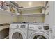 Functional laundry room features modern Samsung washer and dryer, plus convenient shelving at 7669 Fieldfare Dr, North Las Vegas, NV 89084