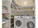 Well-organized laundry room with modern Samsung washer and dryer and ample shelving at 7669 Fieldfare Dr, North Las Vegas, NV 89084