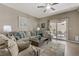 Comfortable living area featuring a plush sofa, decorative pillows, and access to an outdoor patio at 7669 Fieldfare Dr, North Las Vegas, NV 89084
