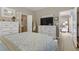 Bright bedroom featuring neutral walls, white furniture, and a view into the en-suite bathroom at 7669 Fieldfare Dr, North Las Vegas, NV 89084