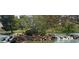 Picturesque pond featuring a rocky waterfall and lush greenery, creating a serene natural setting at 7669 Fieldfare Dr, North Las Vegas, NV 89084