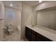 Bathroom featuring large mirror, tile flooring, and granite countertops at 7672 Lush Oasis Ave, Las Vegas, NV 89113