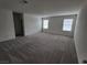 Spacious bedroom with carpet flooring and two windows at 7672 Lush Oasis Ave, Las Vegas, NV 89113