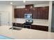 Modern kitchen featuring a stainless steel sink, range, and dark wood cabinets at 7672 Lush Oasis Ave, Las Vegas, NV 89113