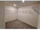 Spacious walk-in closet featuring neutral carpeting and wire shelving for optimal organization at 7672 Lush Oasis Ave, Las Vegas, NV 89113