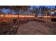 The backyard features string lights, a grill, and patio seating creating a warm, inviting outdoor area at 7728 Whispering River St, Las Vegas, NV 89131