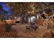 This outdoor patio is illuminated with festive string lights, creating a cozy evening atmosphere at 7728 Whispering River St, Las Vegas, NV 89131