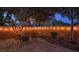 A charming outdoor space with string lights and a patio set offers a magical evening ambiance at 7728 Whispering River St, Las Vegas, NV 89131