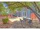 Inviting backyard with stone patio, outdoor dining, mature trees providing shade, perfect for leisure at 7728 Whispering River St, Las Vegas, NV 89131