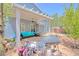 Relaxing backyard with covered patio, barbecue grill, and comfortable seating area, great for outdoor gatherings at 7728 Whispering River St, Las Vegas, NV 89131