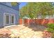 Charming backyard featuring stone patio, outdoor dining set, and lush greenery, creating a serene retreat at 7728 Whispering River St, Las Vegas, NV 89131
