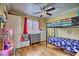 Bright bedroom with a bunk bed, hardwood floors, ceiling fan, and plenty of room for play at 7728 Whispering River St, Las Vegas, NV 89131